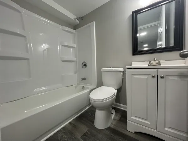 a bathroom with a toilet a sink and bathtub