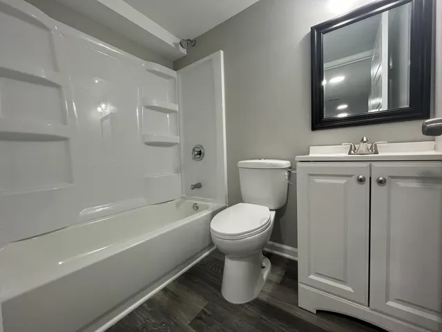 a bathroom with a toilet a sink and bathtub