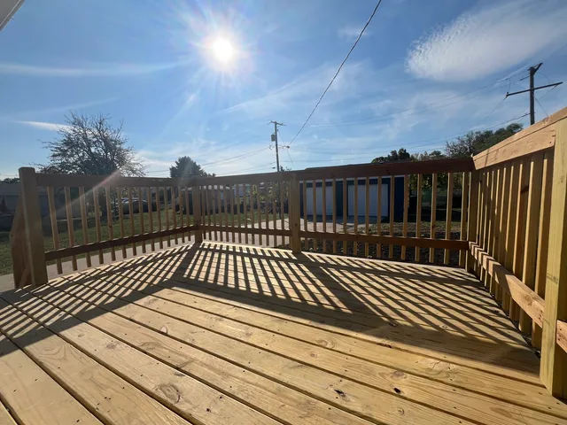 a view of balcony with wooden floor