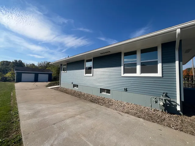 a backyard of a house with large trees