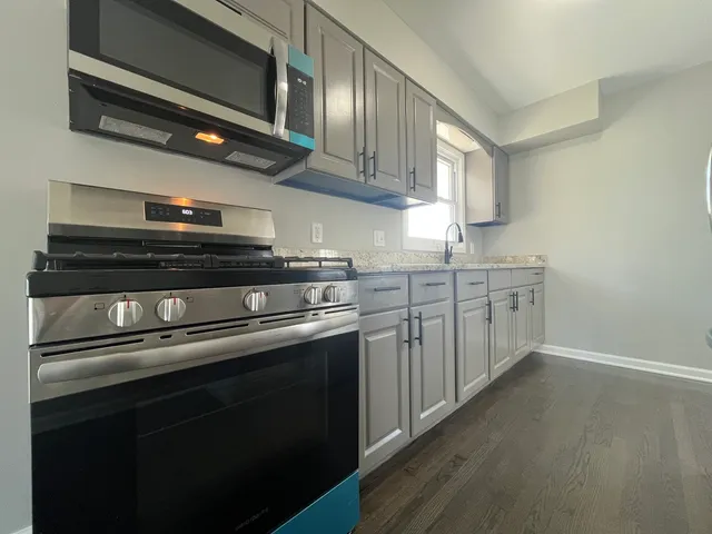 a kitchen with stainless steel appliances granite countertop a stove and a sink