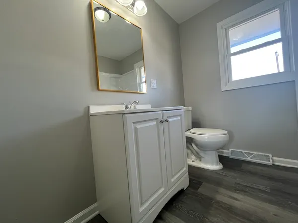 a bathroom with sink toilet and mirror