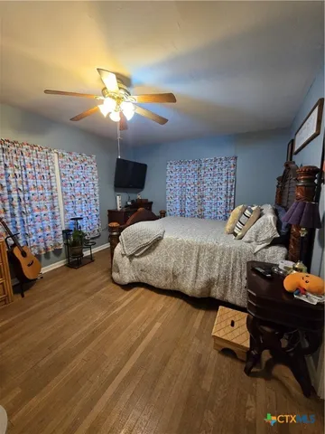 a bedroom with bed and a chandelier