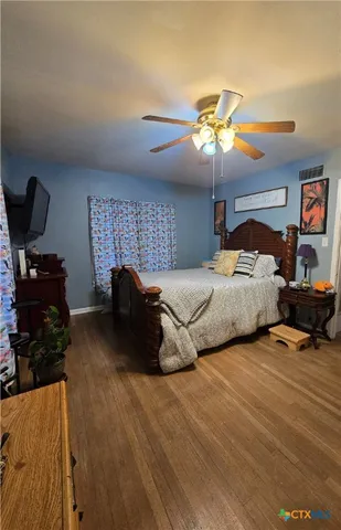 a bedroom with bed and a chandelier