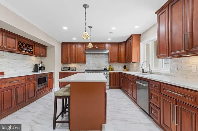 a kitchen with stainless steel appliances a sink stove and cabinets