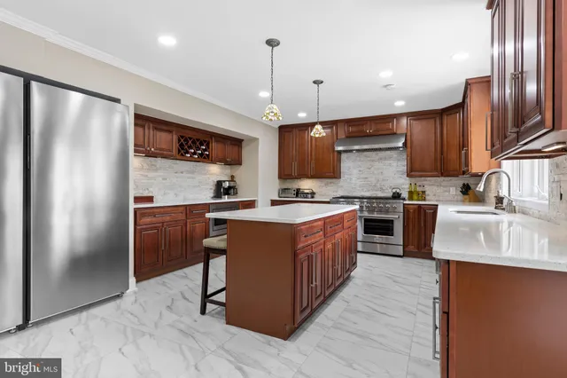 a kitchen with a table chairs sink and cabinets
