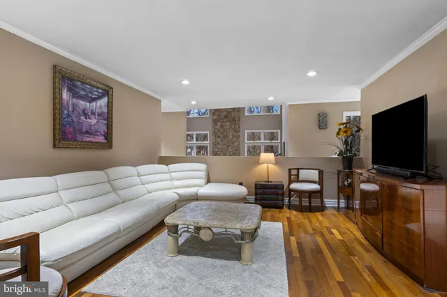 a living room with furniture a fireplace and a potted plant