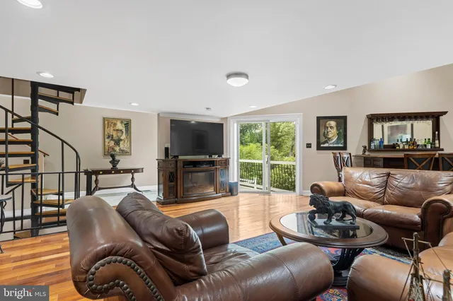 a living room with furniture and a book shelf
