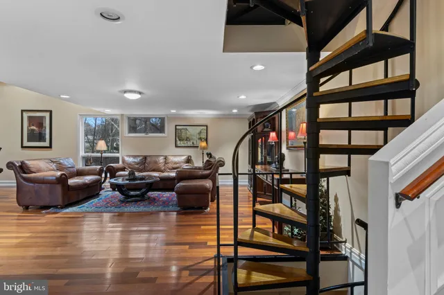 a living room with fireplace furniture and a wooden floor