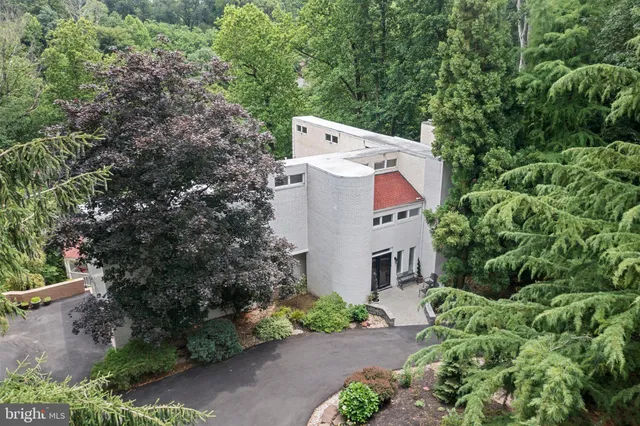 an aerial view of a house with yard and outdoor seating