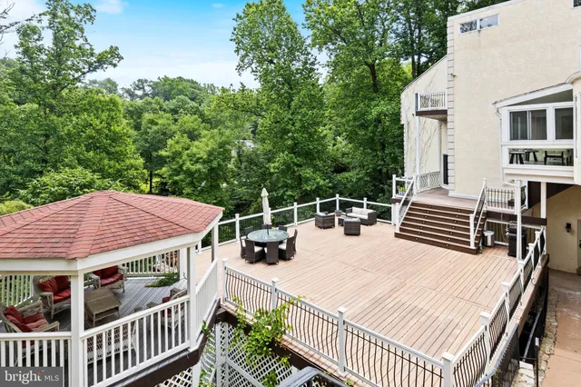 an aerial view of a house with an outdoor space and seating