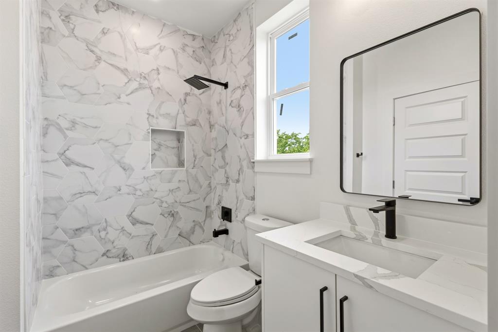 415 North Patton Avenue Dallas, TX 75203 - Photo 15 of 20 Bathroom featuring a white vanity with a rectangular sink, a black faucet, and a black-framed mirror