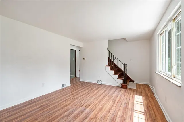 a view of a room with wooden floor and staircase
