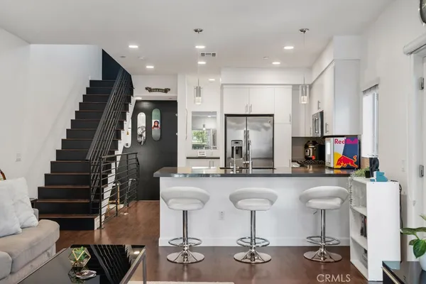 a kitchen with sink refrigerator and cabinets