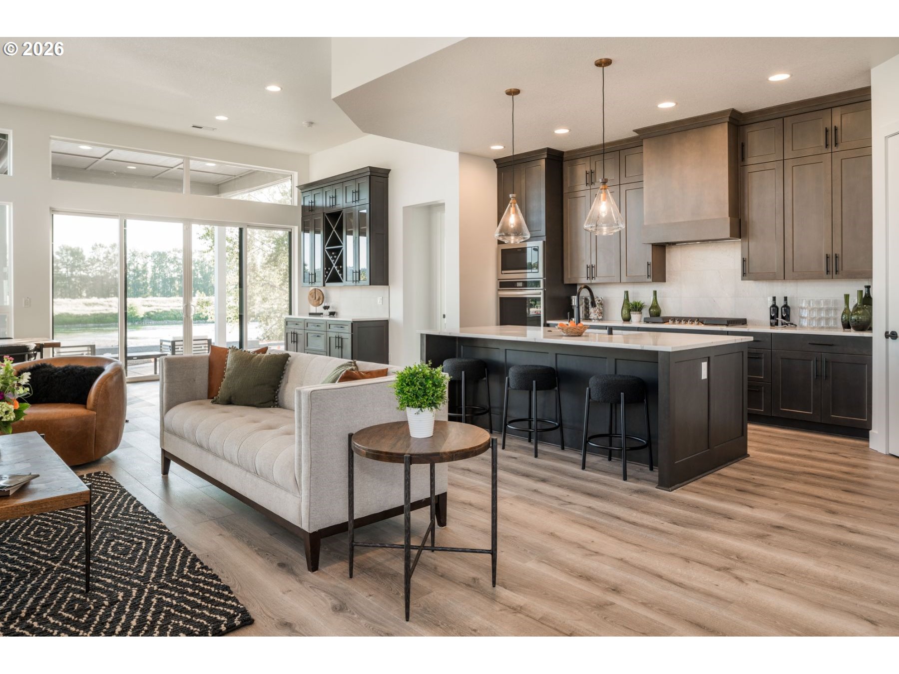 a living room with kitchen island furniture and a wooden floor