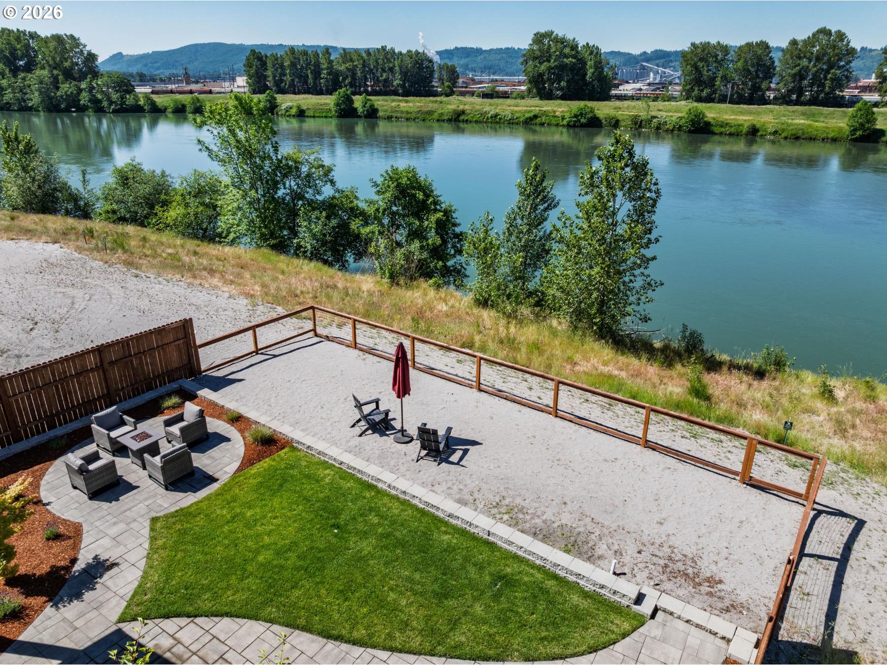 2072 South River Road Kelso, WA 98626 - Photo 15 of 20 a view of a lake with a yard and a wooden fence