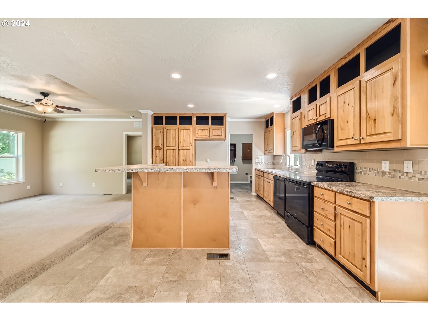 42290 Southeast Shipley Road Sandy, OR 97055 - Photo 3 of 17 a large white kitchen with kitchen island a sink a center island and stainless steel appliances