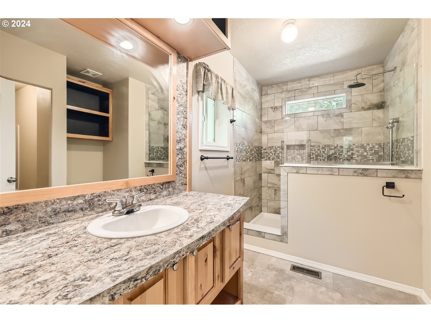 42290 Southeast Shipley Road Sandy, OR 97055 - Photo 10 of 17 a bathroom with a granite countertop sink a mirror and a shower