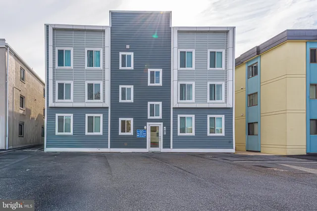 a view of a brick building next to a yard