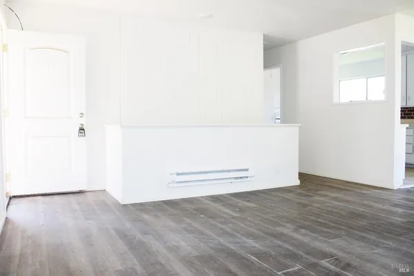 an empty room with wooden floor