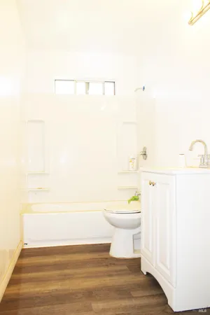a bathroom with a white toilet and a shower