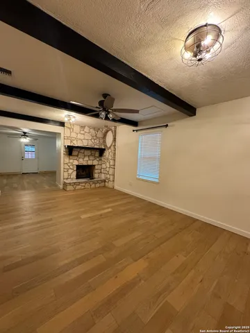 a view of a livingroom with a fireplace and window