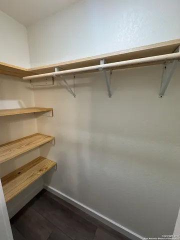 a living room with hard wood floors and a ceiling fan