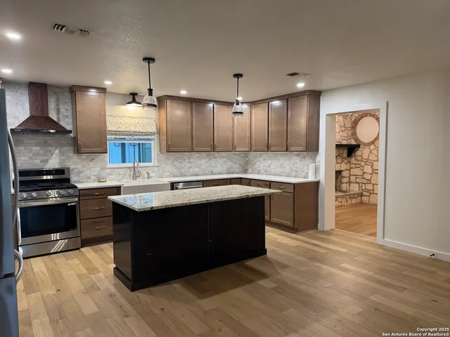 a kitchen with a sink cabinets and stainless steel appliances