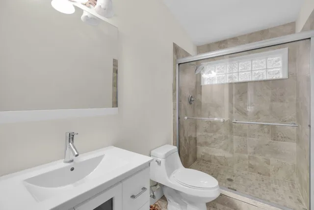 a bathroom with a sink toilet and shower