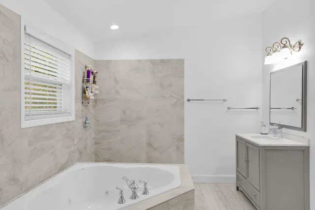 a bathroom with a bathtub and a sink
