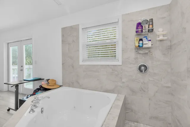 a bathroom with a tub and a window