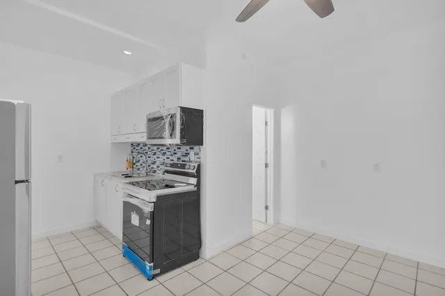 a kitchen with cabinets and steel stainless steel appliances