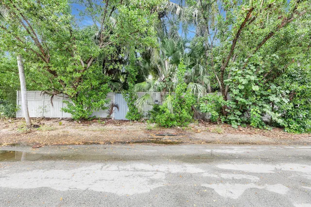 a wooden bench sitting in middle of a yard