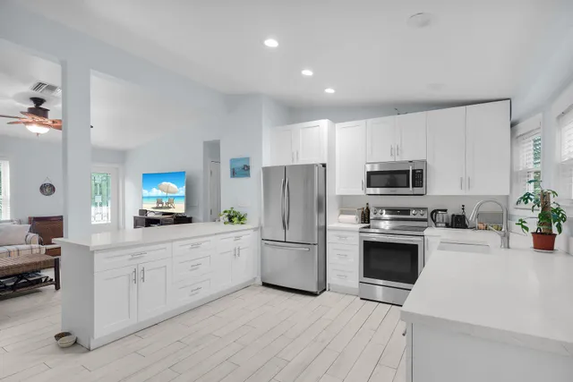 a kitchen with stainless steel appliances a refrigerator stove microwave and sink