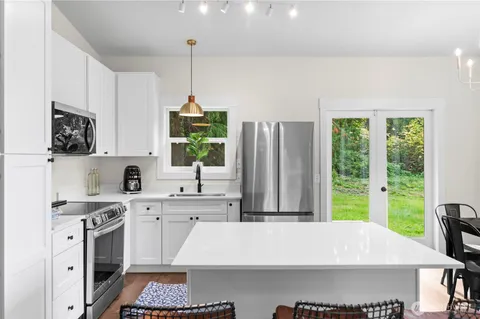 a large white kitchen with a large window