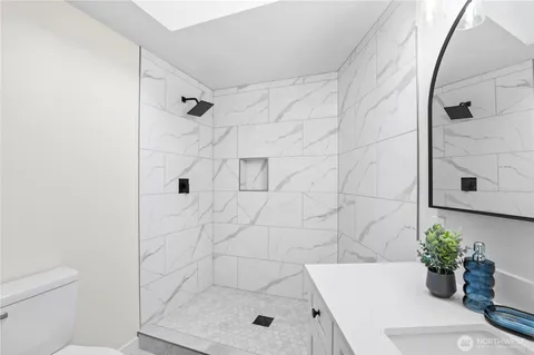 a bathroom with double vanity sink and a mirror