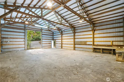 a view of an empty room with a fireplace and windows