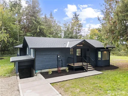 a view of a house with a yard porch and sitting area