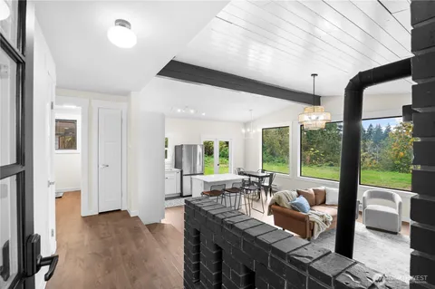 a living room with furniture and large windows