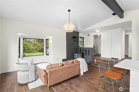 a living room with furniture chandelier and a window