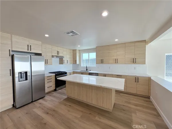 a large kitchen with stainless steel appliances kitchen island granite countertop a large counter top stainless steel appliances and cabinets