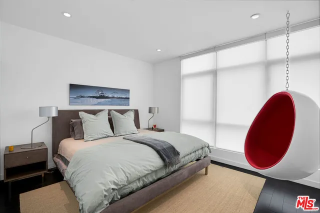 a bedroom with a bed and a chair