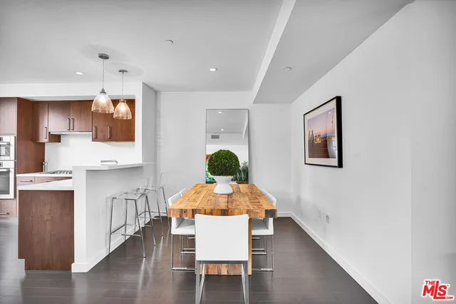 a dining room with wooden floor and a chandelier