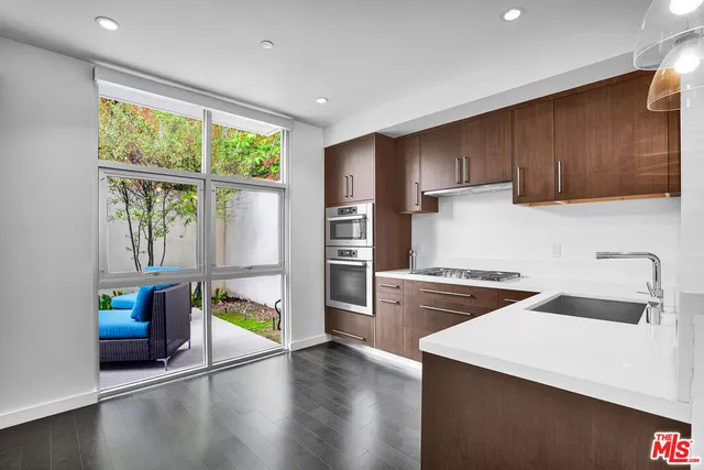 a kitchen with a sink a stove and a refrigerator