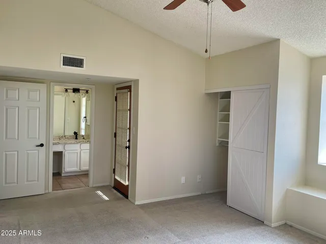 a view of a hallway with closet and cabinet