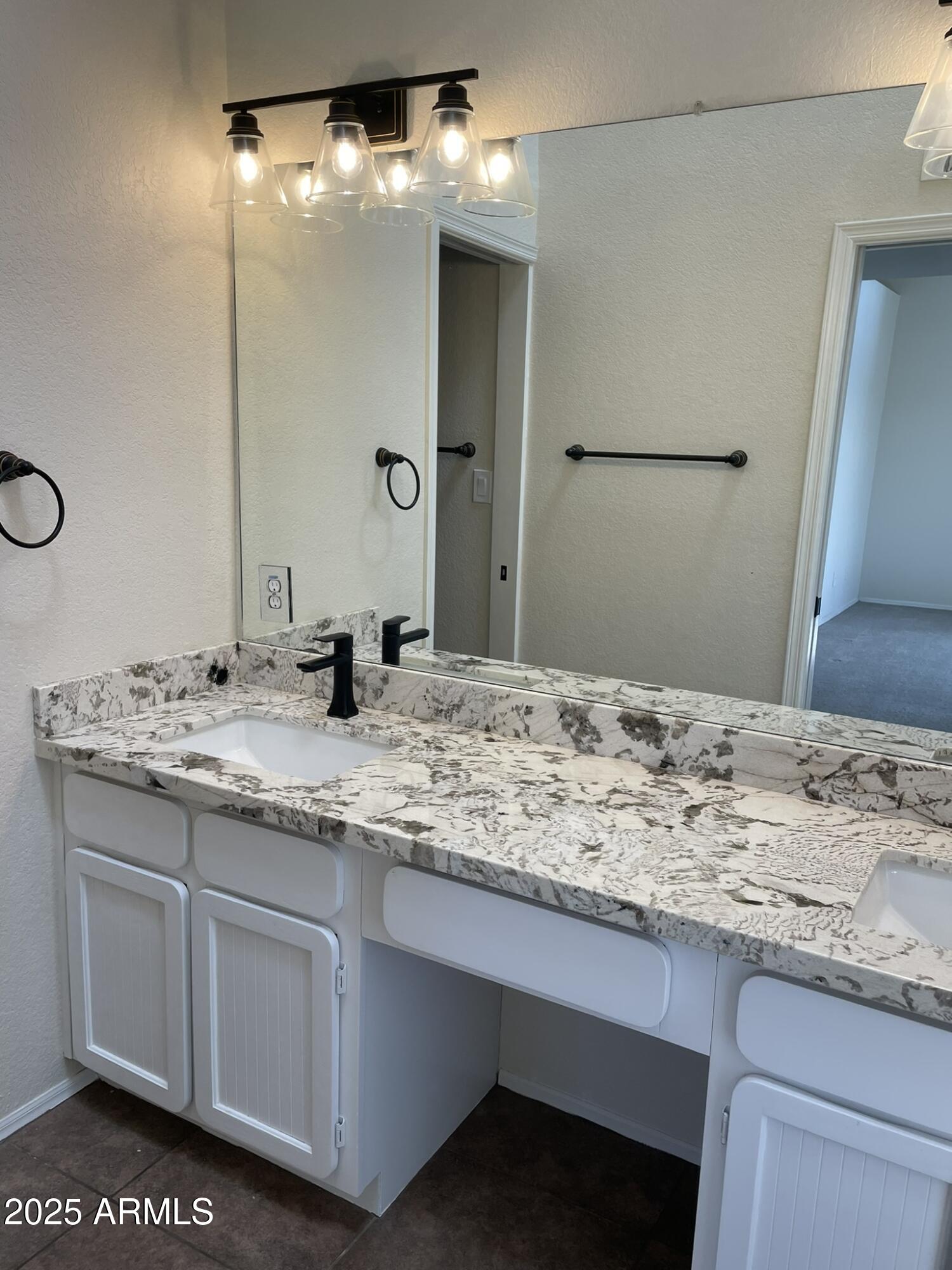 1124 East Rose Lane, Unit 3 Phoenix, AZ 85014 - Photo 15 of 32 a bathroom with a sink and a mirror