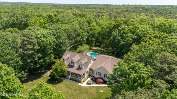 an aerial view of a house with yard outdoor seating and nature view