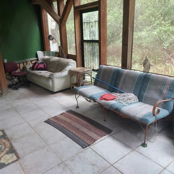 2424 Northeast 170th Street Citra, FL 32113 - Photo 26 of 53 a living room with furniture and a large window