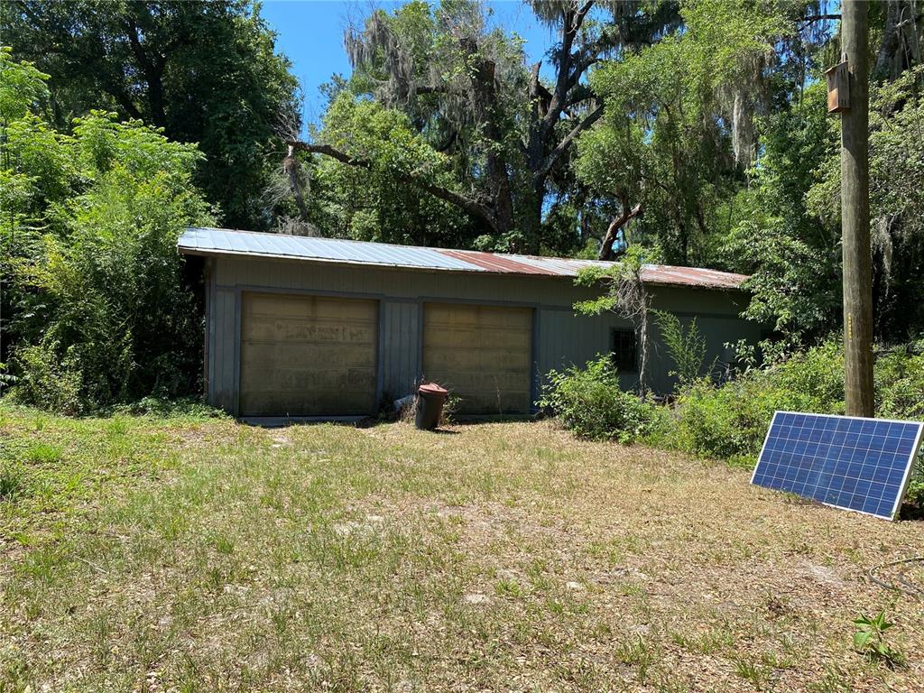 2424 Northeast 170th Street Citra, FL 32113 - Photo 5 of 53 a backyard of a house with a garden and plants