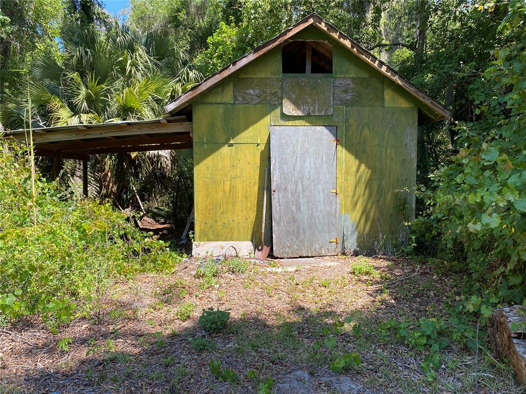 2424 Northeast 170th Street Citra, FL 32113 - Photo 52 of 53 a backyard of a house with wooden fence and deck